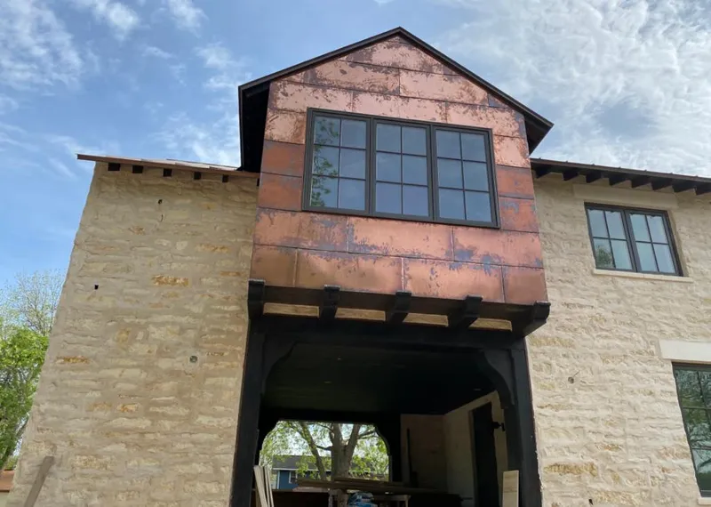 Copper metal panel facade on a stone building for Roof Repair in Silver Springs Shores