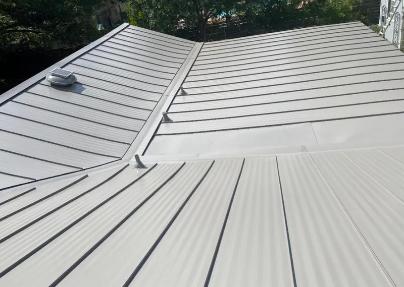 Solar attic fan installed on a metal roof for Roof Ventilation in Silver Springs Shores