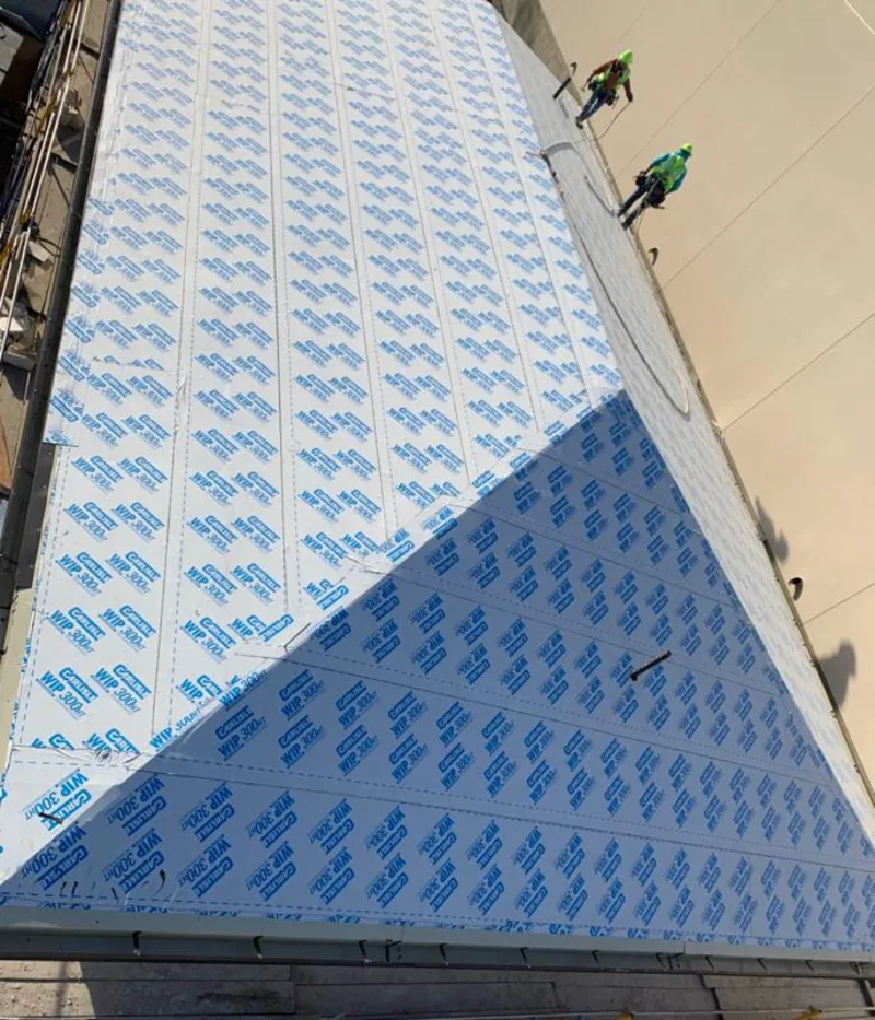 Professional roofers installing underlayment on a metal roof in Silver Springs Shores